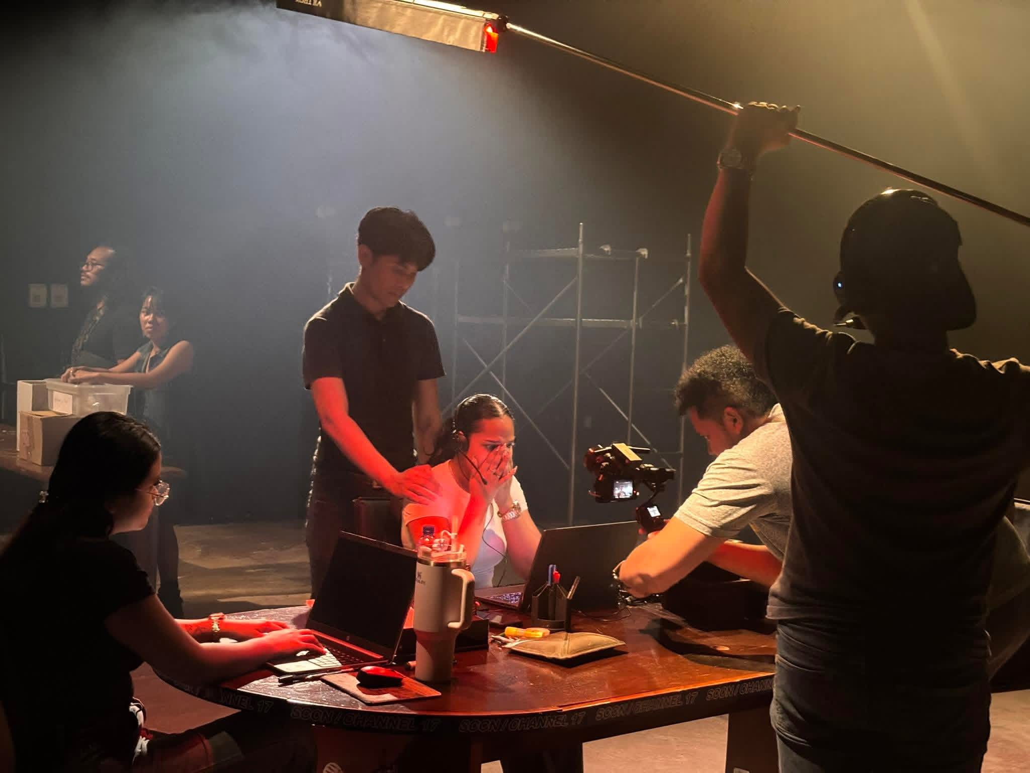 Behind-the-scenes on a Markoesa Productions film set with crew operating a camera boom during a night shoot
